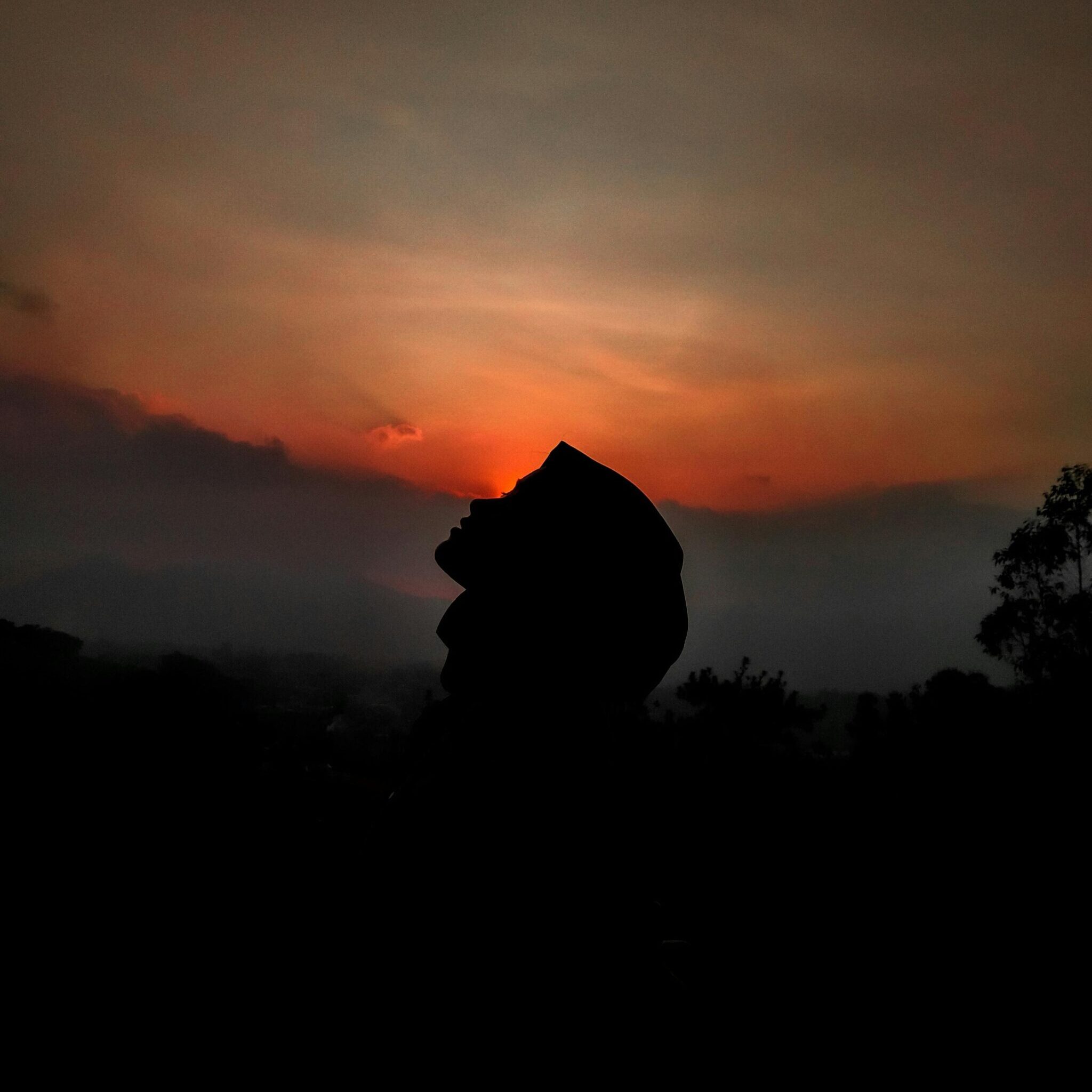 Silhouette of person against sunset sky